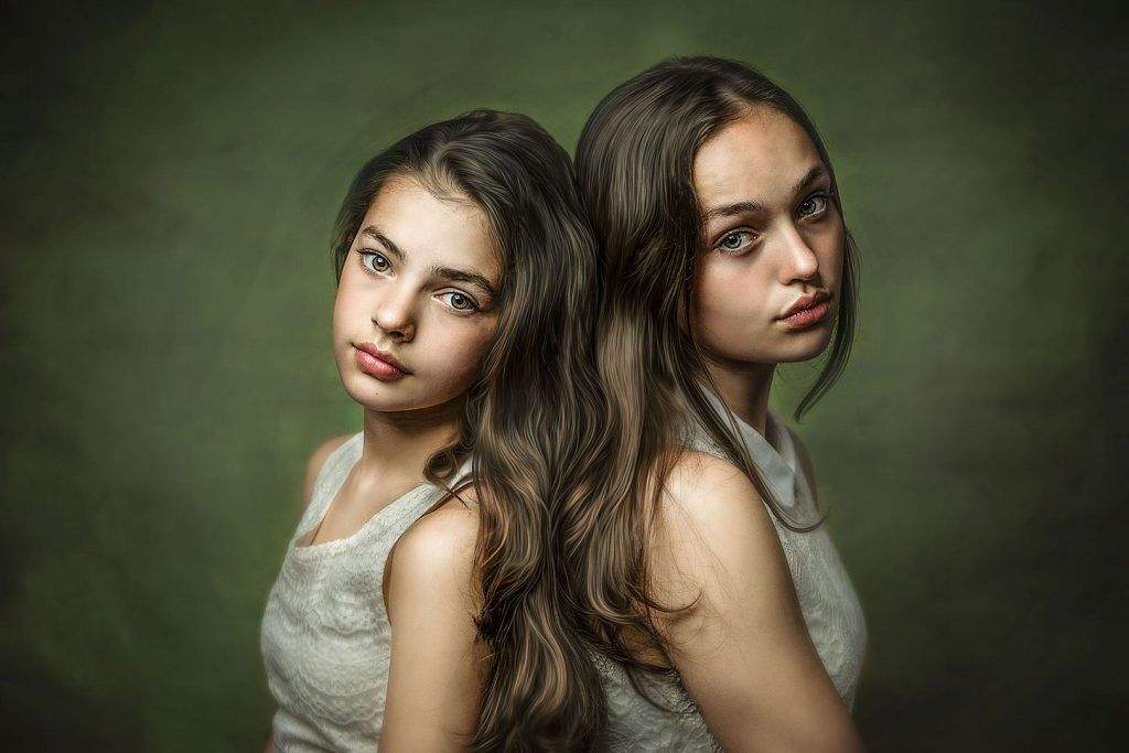 Fine art portrait — sisters standing back to back