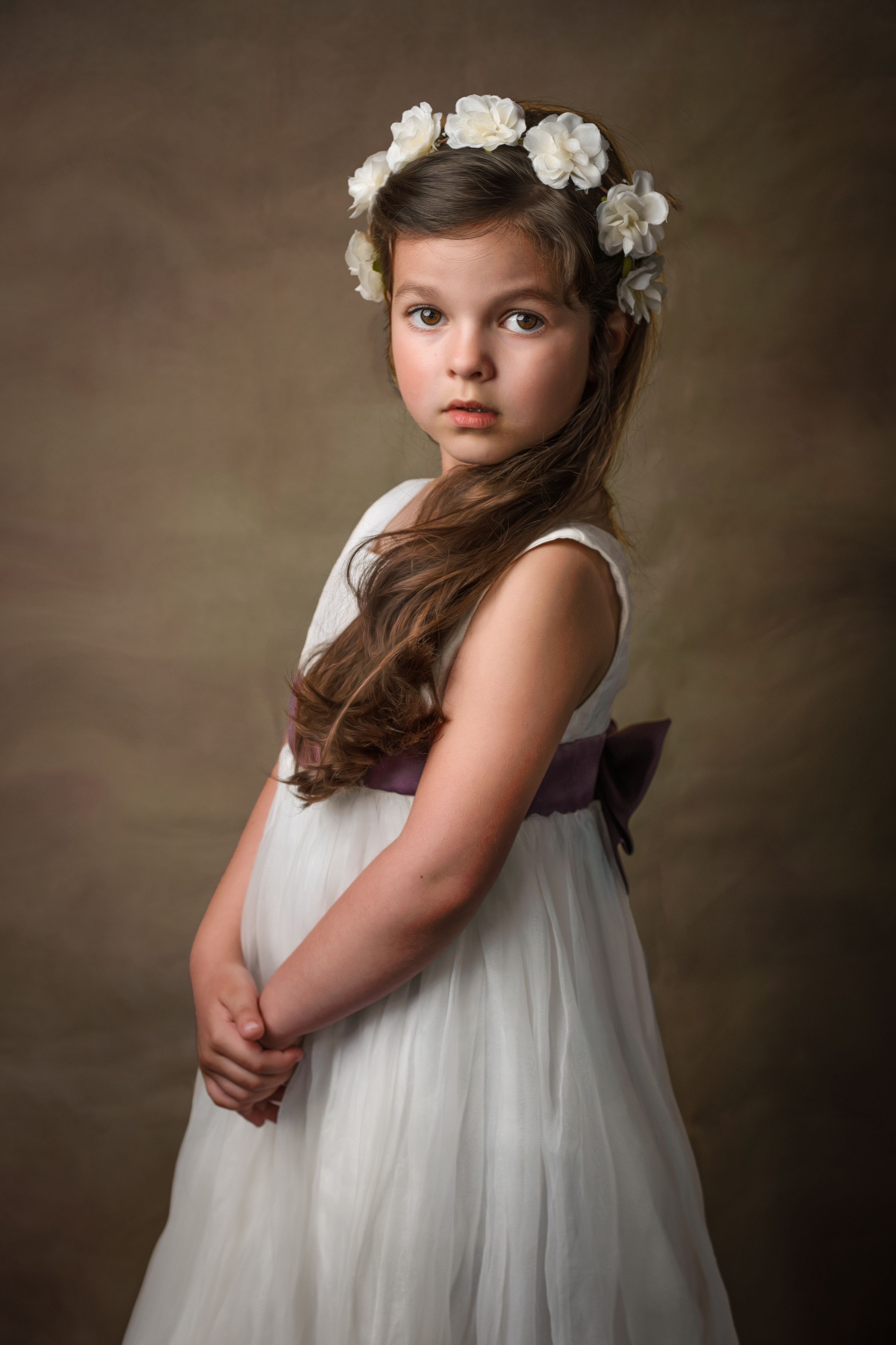 Fine art portrait — girl in a white dress with flowers