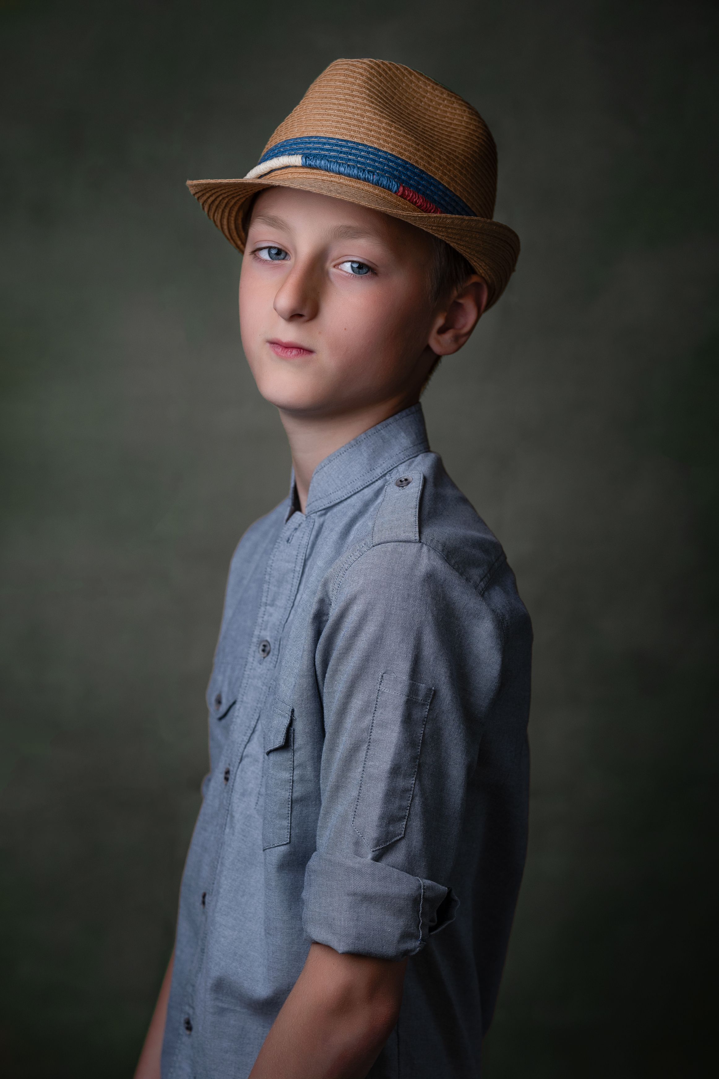 Fine art child portrait — boy in a straw hat