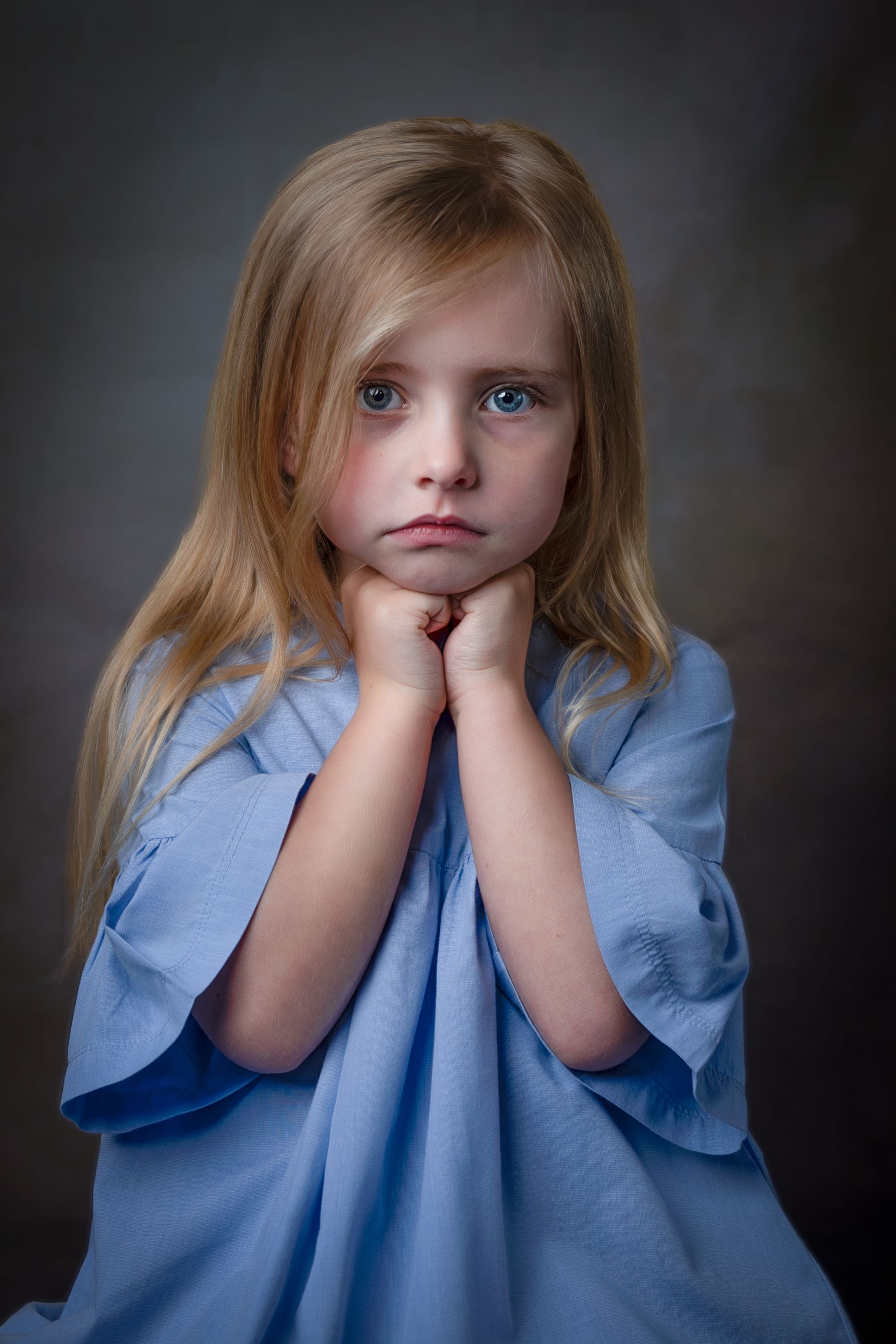 Fine art child portrait — blonde girl in a blue dress
