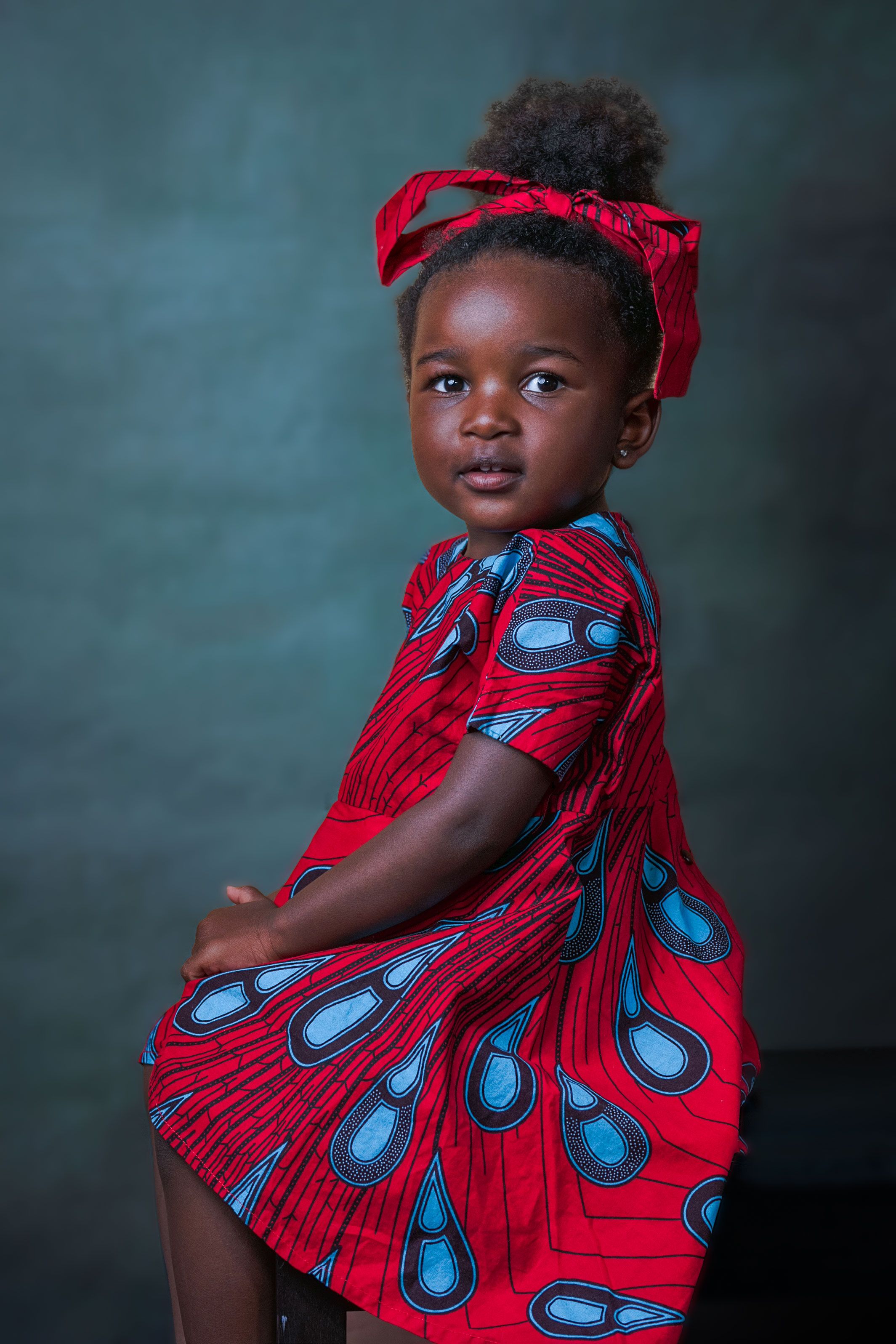 Fine art child portrait — girl in a red patterned dress