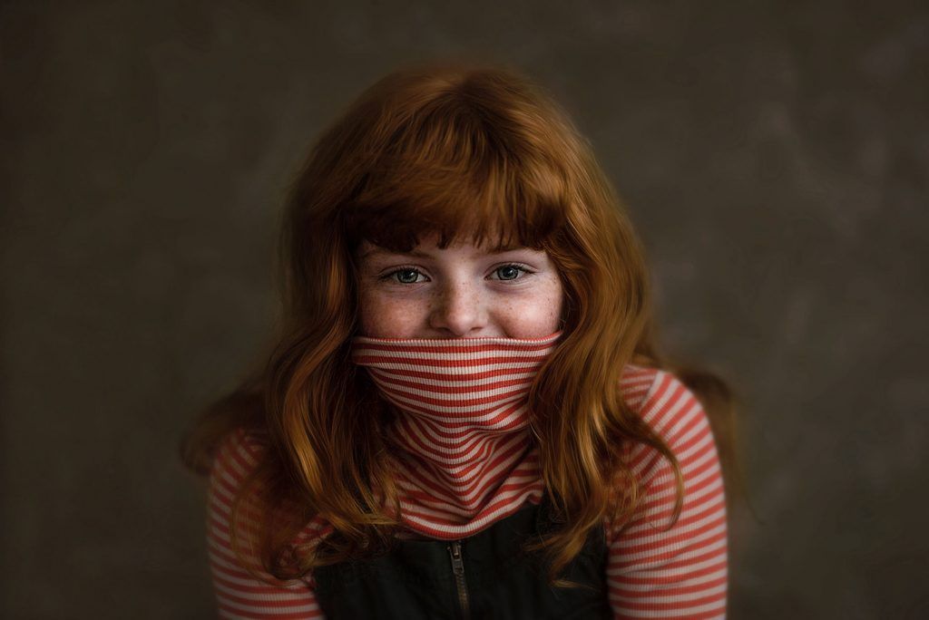 Fine art portrait — red-haired girl in a striped top